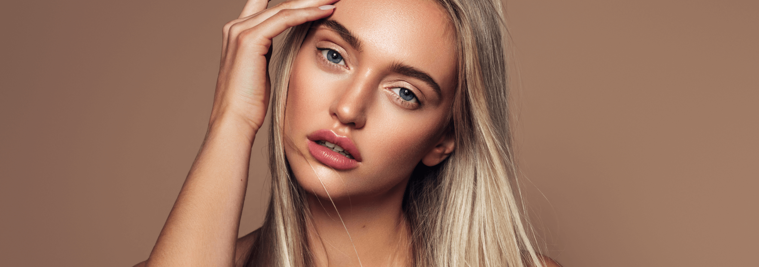 Young woman smiling after her consultation to discuss profhilo and skin boosters at Cambridge Cosmetic Clinic