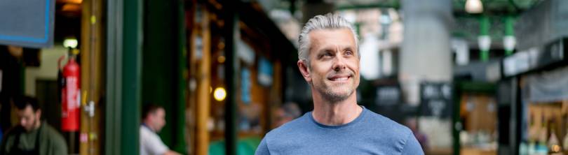 man smiling after polynucleotide treatment for his hair